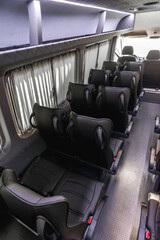comfortable passenger bus interior with upholstered seats; individual transfer for a group of people; conversion of the interior of a truck; 