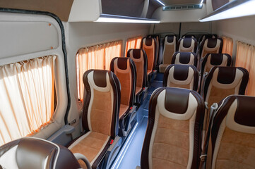 comfortable passenger bus interior with upholstered seats; individual transfer for a group of...