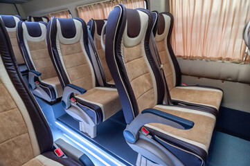 comfortable passenger bus interior with upholstered seats; individual transfer for a group of...