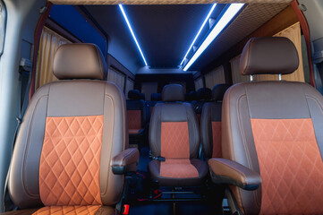 comfortable passenger bus interior with upholstered seats; individual transfer for a group of...