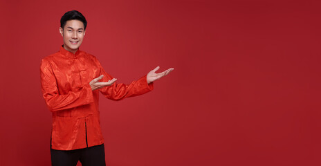Happy Chinese new year. Asian man presenting or showing open hand palm with copy space introduce...