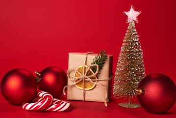 Christmas gift boxes wrapped kraft paper decorated ribbon bow and fir branches on marsala red...