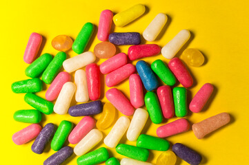 colorful jelly candies on a yellow background