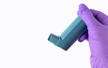 doctor medical assistant hands in purple surgical gloves holding asthma inhaler aerosol...
