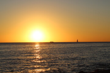 Fototapeta premium Sunset over the sea with boats
