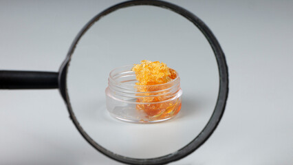 yellow gold cannabis wax in glass container, concentrate marijuana resin