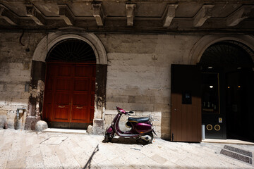 Scooter standing at the empty street of old italian town Bari, Puglia, South Italy.
