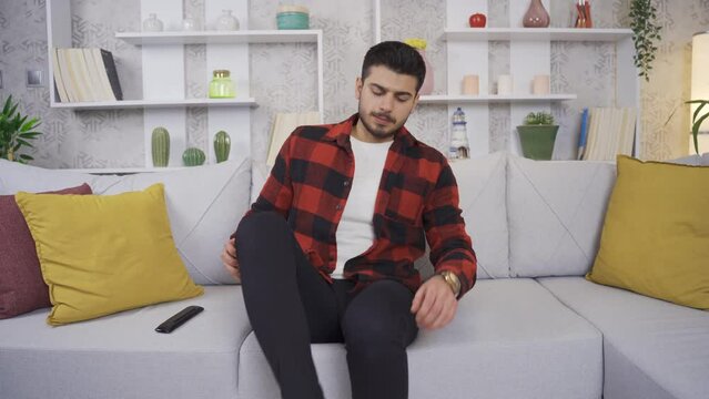 Young men's feet stink and he is disgusted.
The man who comes home takes off his socks and smells bad feet and starts to get disgusted.
