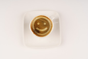 Coffee cup with smiley face in foam.