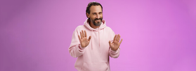 No thanks pass. Charming polite manly adult bearded man grey hair in pink hoodie apologizing...