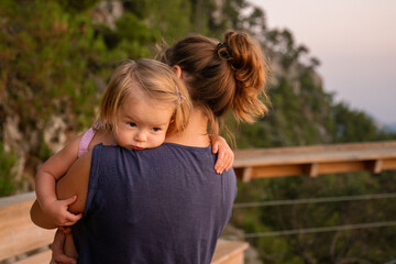 Mom and daughter are hugging at sunset. Beautiful picture of motherhood