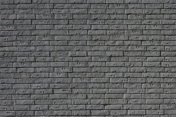 Abstract black background. Black bricks texture. Dark rough wall surface.