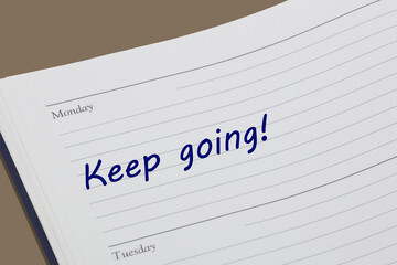 Keep going diary reminder message open on desk