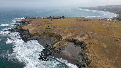 Aerial shot of the pacific ocean, beach and the bay La Pancora at Pichilemu, Chile