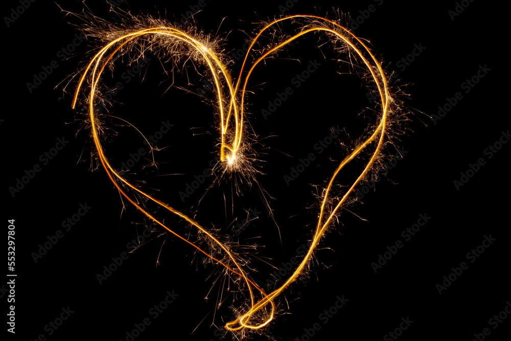 Poster sparkles heart with sparks, using camera with slow shutter speed
