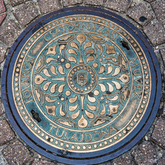 A beautiful brass decorated manhole cover