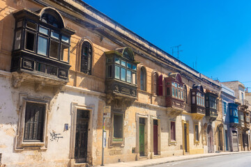 Fototapeta na wymiar Typical colorful balconies of Malta in Valletta