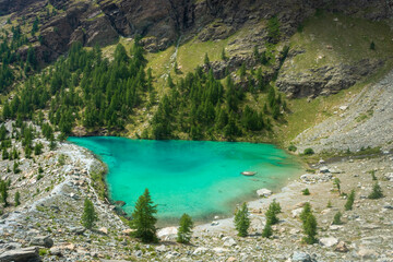 Fototapeta na wymiar The crystal clear water of the Blue Lake of Ayes, Italian Alps