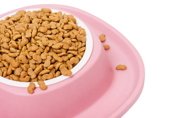 Dry pet food, grain-free formula in a white plate and a pink silicone stand. Food for animals.