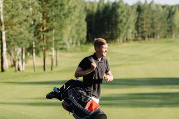 Obraz premium a golfer walks along a green field with a bag in which clubs. Caddy carries clubs. High quality photo