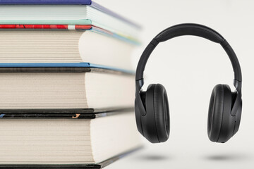 Audiobooks. Audiobook concept, stack of books and headphones with space for copy space. Choice between books and audio.