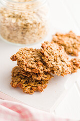 Sweet oatmeal cookies on white kitchen table.