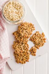 Sweet oatmeal cookies on white kitchen table.