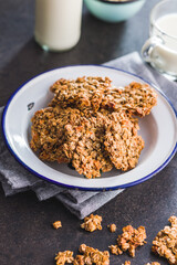 Sweet oatmeal cookies on plate on kitchen table.