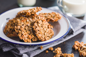 Sweet oatmeal cookies on plate on kitchen table.