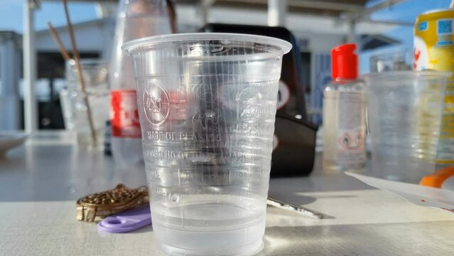  Single use Beverage plastic cup used on a restaurant table,disposable waste pollution concept