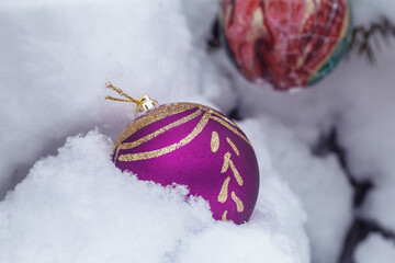 red christmas ball on snow