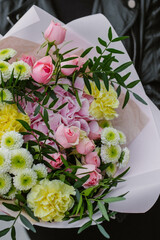 Big floral bouquet with roses and hydrangea in woman hands