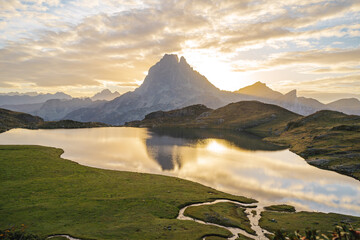 Pic du Midi d'Ossau at sunrise, with its reflection on the Lake Gentau, Ossau Valley / Pyrenees - obrazy, fototapety, plakaty