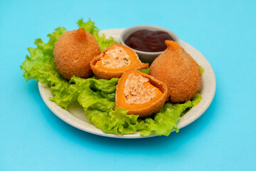 traditional brasilian fried drumsticks Coxinha de frango on dish