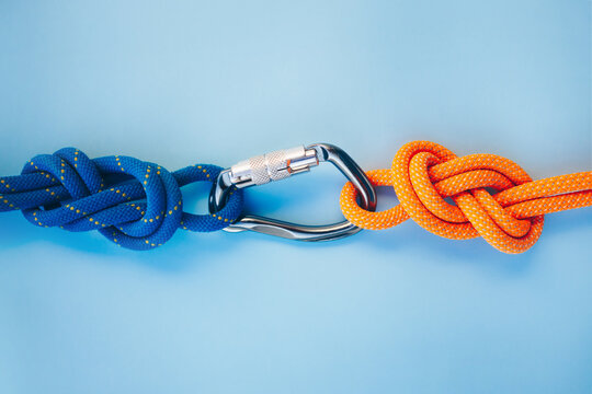 Grey carbine with clutch. Equipment for climbing and mountaineering. Safety rope. Knot eight