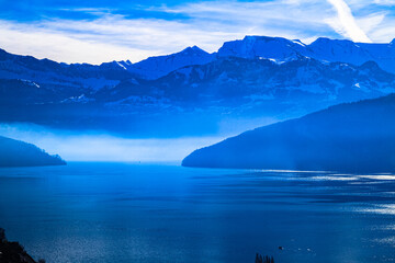 Fototapeta na wymiar Swiss Alps panoramic skyline misty view over lake Lucern Switzerland
