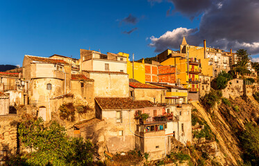 old mediterranean mountain dense town with levels of yellow houses and terraces on a mountain in...