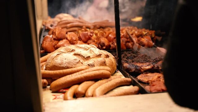 Traditional baked bread in vintage style stone made furnace. Puffing steam, heat and fresh, Natural organic handmade food. Roasted fat smoked and grilled pork legs, sausage nad  shashliks.