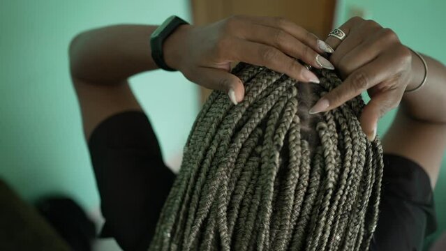 Young millennial girl showing box draids hairstyle. one fashionable black woman with long hair in dreadlocks