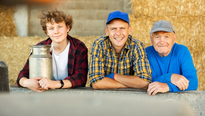 Portrait of farmers of different generations against the background of hay bales. Concept of...