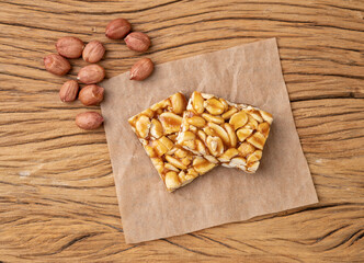 Pe de moleque, typical brazilian peanut candy and june festival food over wooden table