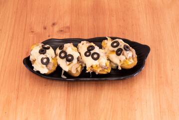 Roasted potatoes stuffed with mushrooms, black olives and melted cheese