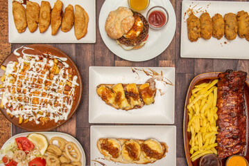 Spanish food dishes and tapas set, goat cheese and onion toasts, fried calamari, roast rib,...