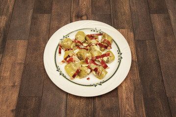 A Spanish tapa of fried artichoke hearts with strips of serrano ham