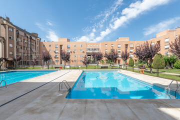 Interior facades of a block patio of residential buildings with gardens and summer swimming pools with gardens and decorative trees