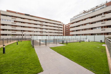 Fototapeta premium Facades of residential buildings with gray granite, community pool and lawned gardens