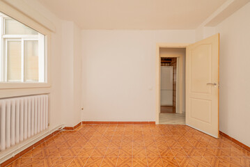 Empty living room with ugly brown tiled floor, orange painted walls, electric heater and white ceiling fan