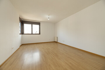 empty living room with wooden flooring and brown anodized aluminum corner windows