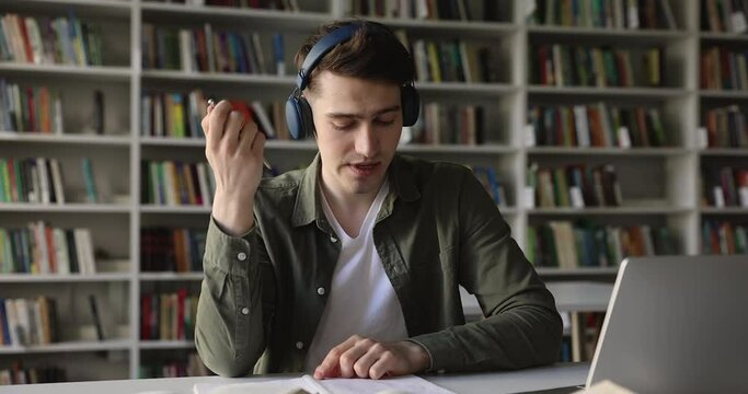 Highschool Student In Headphones Talk To Online Teacher, Take Notes Studying In Library, Take Part In Video Call, Improve Foreign Language Knowledge Using Internet. Education, Virtual Meeting Event