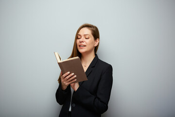 Smiling woman teacher reading book. Isolated portrait with copy space.